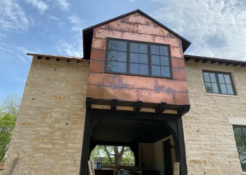 Copper metal panel facade on a stone building for Skylight Installation in Laie