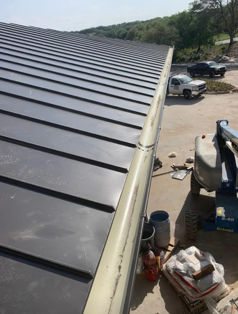 Standing seam panel and gutter detail on a metal roofing jobsite in Laie